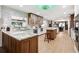 A spacious kitchen features an island, wooden cabinets, granite countertops and opens to the dining area at 36601 Roberts Rd, Dade City, FL 33525