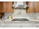 A kitchen cooktop has a modern vent hood and matching backsplash at 36601 Roberts Rd, Dade City, FL 33525
