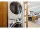 Convenient laundry area with stacked washer and dryer, with view to dining area at 36601 Roberts Rd, Dade City, FL 33525