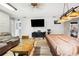 Spacious living room with a sofa, TV, wood floors, and natural light at 36601 Roberts Rd, Dade City, FL 33525