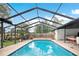 Relax in this screened-in pool with clear water and a surrounding deck with a hammock to the side at 36601 Roberts Rd, Dade City, FL 33525