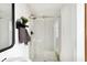 Modern walk-in shower with glass doors, white subway tile, neutral floor tile and black hardware at 36601 Roberts Rd, Dade City, FL 33525