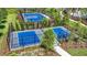 Recreational area showcasing community sport courts for basketball and pickleball surrounded by lush landscaping and secure fencing at 3705 Forest Path Dr, Plant City, FL 33565