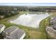 Aerial view of homes backing onto a large pond, highlighting the community's waterfront properties and serene setting at 38190 Shale Stone Ct, Zephyrhills, FL 33540