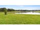 Well-manicured backyard boasts a lush lawn, tranquil pond, and peaceful surroundings at 38190 Shale Stone Ct, Zephyrhills, FL 33540