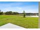 Lush backyard features a pond view, green grass, and serene surroundings at 38190 Shale Stone Ct, Zephyrhills, FL 33540