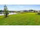 Lush backyard features a pond view, green grass, and community surroundings at 38190 Shale Stone Ct, Zephyrhills, FL 33540