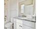 Bathroom featuring granite countertop, white cabinets, and a tiled shower at 38190 Shale Stone Ct, Zephyrhills, FL 33540