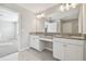 Bathroom featuring a double vanity with granite countertops and white cabinets at 38190 Shale Stone Ct, Zephyrhills, FL 33540