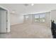 Spacious bonus room with neutral carpet, bright windows, and white trim throughout at 38190 Shale Stone Ct, Zephyrhills, FL 33540