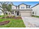 Charming two-story home with stone accents, manicured landscaping, and a paved driveway at 38190 Shale Stone Ct, Zephyrhills, FL 33540