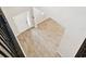 Bright foyer with wood-look tile flooring and a modern front door, viewed from above at 38190 Shale Stone Ct, Zephyrhills, FL 33540