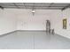 Clean garage features a durable floor, white walls, and ample storage space at 38190 Shale Stone Ct, Zephyrhills, FL 33540