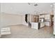 Open-concept living space with a modern kitchen, granite countertops, stainless appliances, and tiled floors at 38190 Shale Stone Ct, Zephyrhills, FL 33540