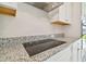 Granite countertops with electric stove and stainless steel hood at 38190 Shale Stone Ct, Zephyrhills, FL 33540