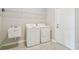 Well-equipped laundry room featuring a utility sink, shelving, and a washing machine and dryer at 38190 Shale Stone Ct, Zephyrhills, FL 33540