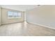 Well-lit living room with light-colored walls, recessed lighting and wood-look tile floors at 38190 Shale Stone Ct, Zephyrhills, FL 33540