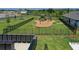 Community playground with a fence, a play structure, a swing set, and nearby mailboxes at 38190 Shale Stone Ct, Zephyrhills, FL 33540
