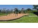 Community playground featuring a swing set, slide, and play structure with wood chip ground cover at 38190 Shale Stone Ct, Zephyrhills, FL 33540