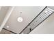 Staircase with decorative iron railing and modern pendant lighting overhead at 38190 Shale Stone Ct, Zephyrhills, FL 33540