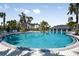 Large community pool with palm trees and lounge chairs creates a resort-like atmosphere at 4033 Northern Key Dr, Plant City, FL 33563