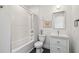 Bathroom featuring a bathtub with shower, white tile, and a vanity sink at 411 W Frances Ave # 2, Tampa, FL 33602