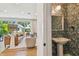 Half bathroom features floral wallpaper, pedestal sink, and modern lighting at 411 W Frances Ave # 2, Tampa, FL 33602