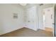 Neutral bedroom with carpeted floors, closet, and access to a bright hallway at 411 W Frances Ave # 2, Tampa, FL 33602
