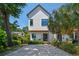 Charming two-story home with white siding, modern windows, and lush landscaping, enhancing its curb appeal at 411 W Frances Ave # 2, Tampa, FL 33602