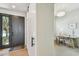 Modern foyer with a sleek black door, hardwood floors, and an adjacent study area, creating a versatile entryway at 411 W Frances Ave # 2, Tampa, FL 33602