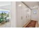 Hallway with white storage cabinets, wood floors, and a decorative rug at 411 W Frances Ave # 2, Tampa, FL 33602