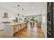 Spacious kitchen featuring a large island with bar seating, modern appliances, and an open flow to the living area at 411 W Frances Ave # 2, Tampa, FL 33602
