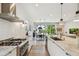 Open concept kitchen with stainless appliances, marble counters, and a dining area with sliding glass doors at 411 W Frances Ave # 2, Tampa, FL 33602