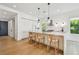 Sleek modern kitchen features an island with barstool seating, stylish pendant lights, and a sliding barn door at 411 W Frances Ave # 2, Tampa, FL 33602