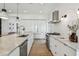 Well-lit kitchen with stainless steel appliances, marble counters, and sleek white cabinets at 411 W Frances Ave # 2, Tampa, FL 33602