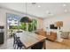 Open concept living and dining area featuring hardwood floors and backyard views at 411 W Frances Ave # 2, Tampa, FL 33602