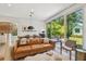 Open-concept living room with modern furnishings and sliding glass doors to outdoor patio at 411 W Frances Ave # 2, Tampa, FL 33602