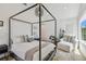 Spacious bedroom with four-poster bed, seating area, and modern decor at 411 W Frances Ave # 2, Tampa, FL 33602