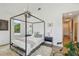 Bright bedroom with four-poster bed, modern decor and hardwood floors at 411 W Frances Ave # 2, Tampa, FL 33602