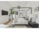 Bedroom with a four-poster bed, wood floors, and large window for natural light at 411 W Frances Ave # 2, Tampa, FL 33602