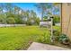 Spacious backyard featuring a greenhouse and birdbath, perfect for gardening and enjoying nature at 4180 Jacaranda Cir, Brooksville, FL 34604