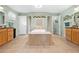 Bathroom featuring a large soaking tub, tiled floors, and light green walls at 4180 Jacaranda Cir, Brooksville, FL 34604