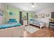 Charming bedroom features two twin beds, wood floors, and bright, colorful decor at 4180 Jacaranda Cir, Brooksville, FL 34604