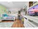 Comfortable bedroom showcasing twin bed, wood floors, TV, and a dresser at 4180 Jacaranda Cir, Brooksville, FL 34604