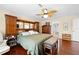 Bedroom with hardwood floors, ceiling fan, wooden headboard and a padded bench at the end of the bed at 4180 Jacaranda Cir, Brooksville, FL 34604