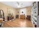 Bedroom with wood floors, ceiling fan, curated decor, and plenty of natural light from the window at 4180 Jacaranda Cir, Brooksville, FL 34604