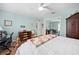 Bright bedroom with wood floors, ceiling fan, office space, furnishings, and large closet at 4180 Jacaranda Cir, Brooksville, FL 34604