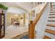 Open dining room features tile flooring, columns, staircase, and a chandelier at 4180 Jacaranda Cir, Brooksville, FL 34604