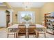 Bright and airy dining room with large windows, a chandelier, and elegant furnishings at 4180 Jacaranda Cir, Brooksville, FL 34604