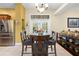 Bright dining area next to kitchen with stainless steel appliances and doors to the backyard at 4180 Jacaranda Cir, Brooksville, FL 34604